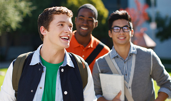 Three male Educatius Academy students is walking and laughing.