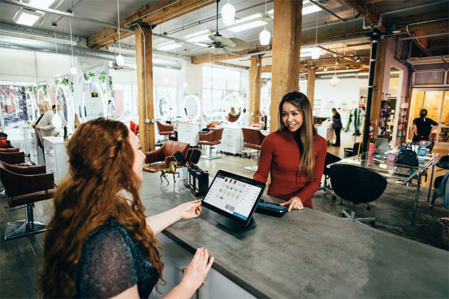 Two female students is sitting at a counter, studying single courses.